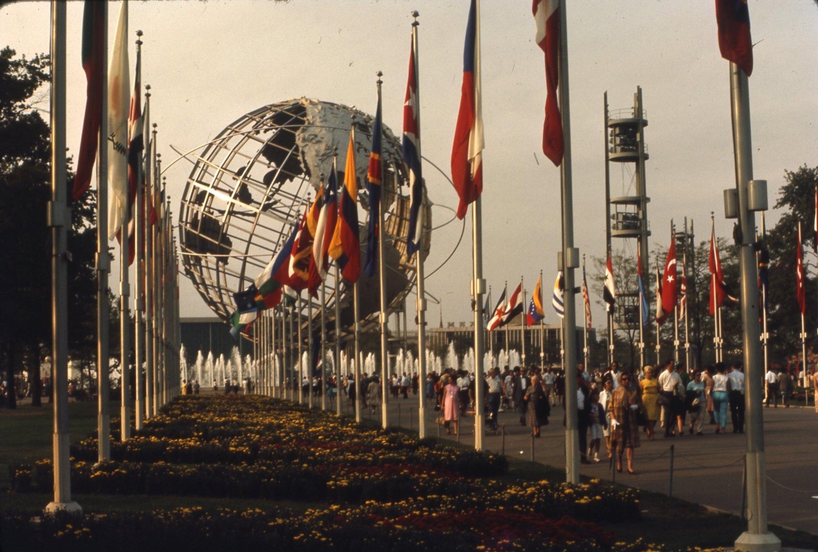 The Unisphere and a row of flags at the 1964 New York World’s Fair