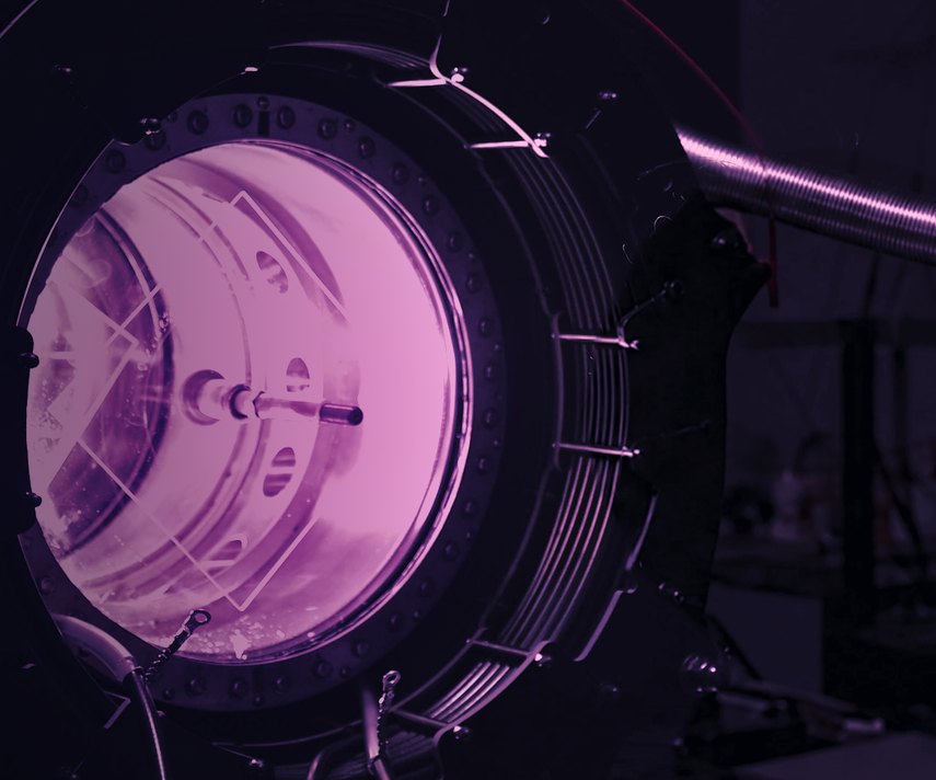 A machine in Marathon Fusion’s lab, its round window glowing purple